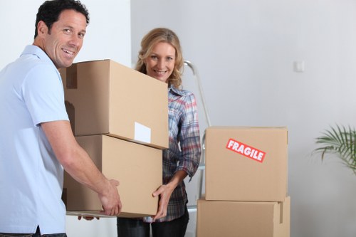 Packed moving boxes and wrapped furniture ready for collection